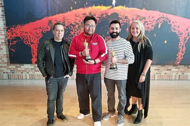 Lyon Liew Lyon holding the Oscar with Coco's director Lee Unkrich, co-director Adrian Molina and producer Darla K. Anderson.