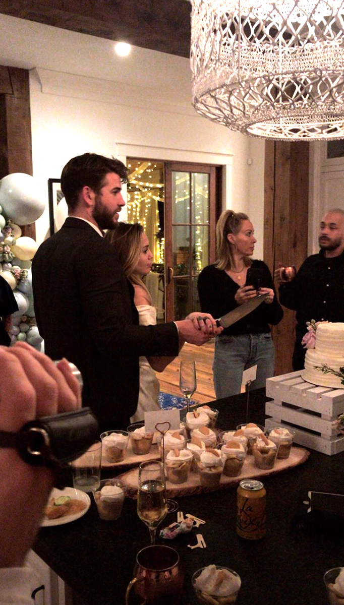 The newlyweds cutting their wedding cake.