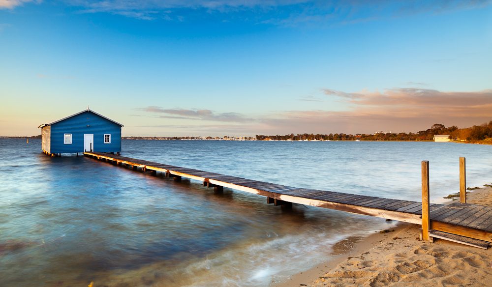australiantraveller.com The iconic boat shed sits atop the calm waters of Swan River.