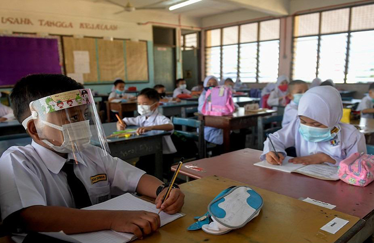 Bernama Students can also wear facemasks underneath face shields for extra protection.
