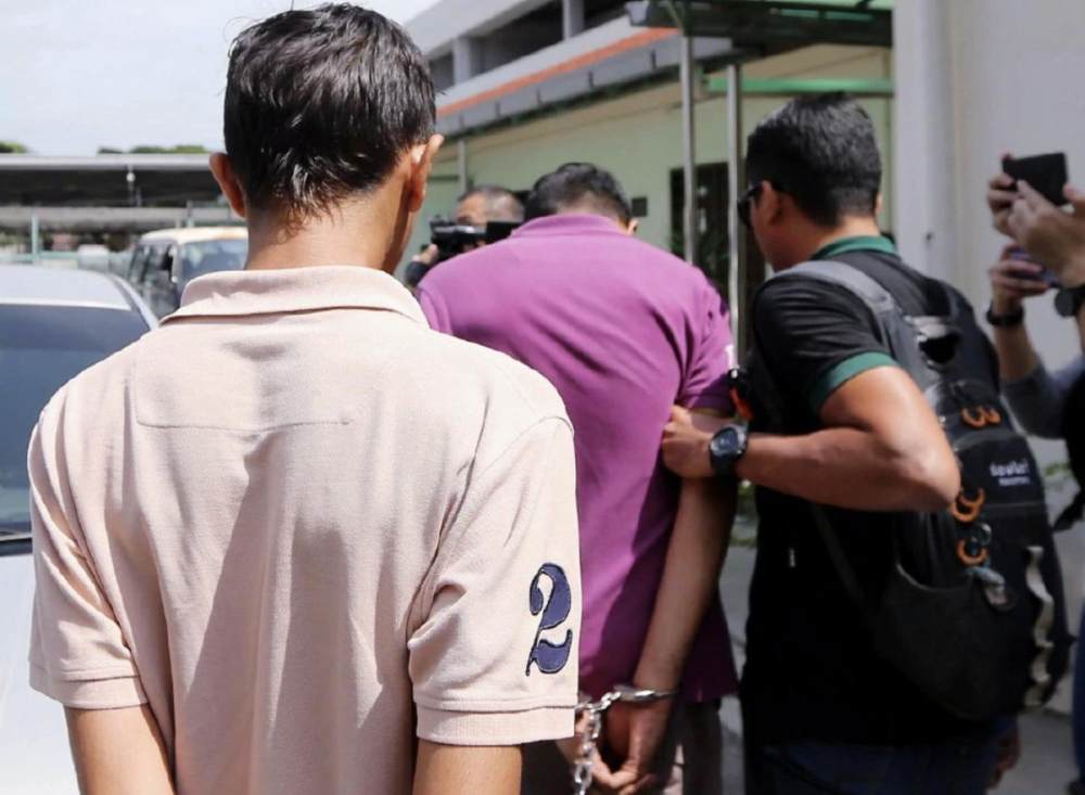 Malay Mail Suspects being led away by the police